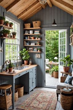 a room filled with lots of potted plants next to a kitchen sink and window