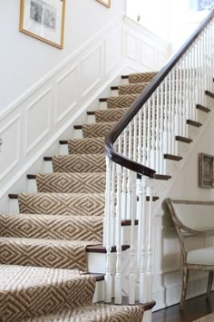 an image of a staircase with carpet on the bottom and handrails above it