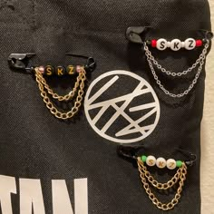 three pairs of eyeglasses are hanging on a black tote bag with the word skin written on it