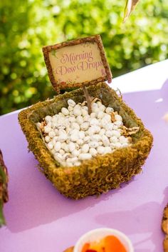 a purple table topped with marshmallows and cookies