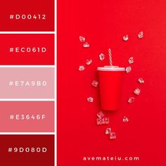 a red cup with a straw in it surrounded by cubes and confetti