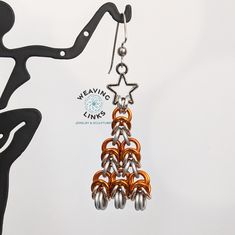 Earrings in the shape of trees! They are festive and look like they are still in the forest covered in snow. Ready to ship. Hangs from stainless steel french hook ear wires. Made with anodized aluminum rings. Approx 2" long. Ready to ship. Nickel-free Orange Earrings For Gift, Christmas Tree Wire Earrings, Tiger Tree Earrings, Orange Nickel-free Earrings For Halloween, Silver Fish-shaped Earrings With Fish Hooks, Snowy Trees, Christmas Tree Earrings, Earring Tree, Ear Wires