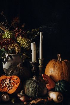 pumpkins, gourds and candles on a table