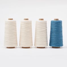 three spools of thread sitting next to each other