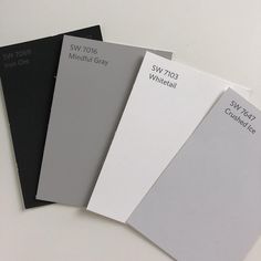 four different shades of paint sitting next to each other on top of a white table