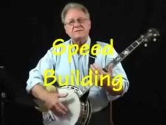 a man holding a white guitar with the words speed building in front of him on it