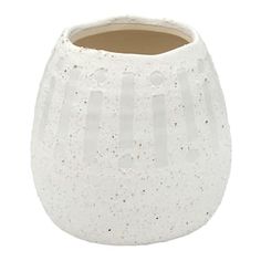 a white vase with speckles on the outside and inside, sitting in front of a white background