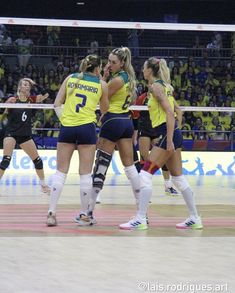 the women are playing volleyball on the court