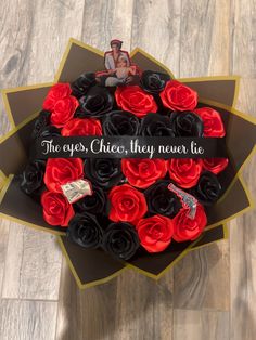 a bouquet of red and black roses in a box with the words, yes chees they never lie