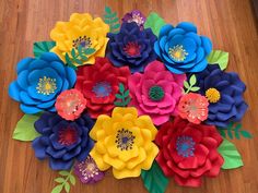 paper flowers are arranged on a wooden table