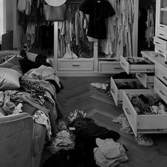 the closet is full of clothes and other things to wear in it's storage area