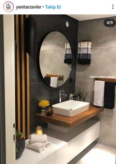 a bathroom with a sink, mirror and towel rack on the wall in front of it