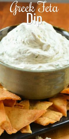 greek feta dip in a bowl surrounded by tortilla chips on a plate