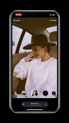 a woman wearing a hat sitting in the back seat of a car