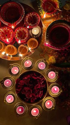 candles and bowls are arranged on a table with decorative items in the middle, along with other decorations