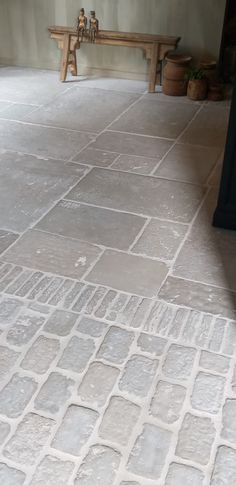 a bench sitting on top of a stone floor