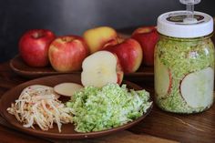 apples and shredded cabbage on plates next to a mason jar