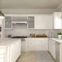 a kitchen with white cabinets and countertops has a black and white striped rug on the floor