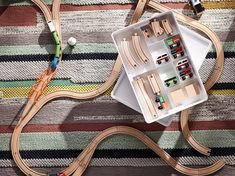 a toy train set with wooden tracks and accessories