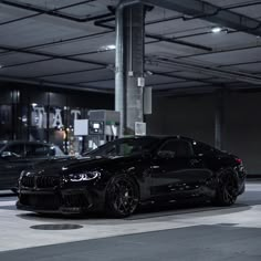 a black car parked in a parking garage