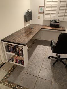 an office with a desk, chair and bookshelf in the middle of it