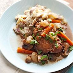 a white plate topped with meat and vegetables