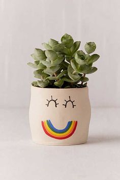 a potted plant with a face painted on it