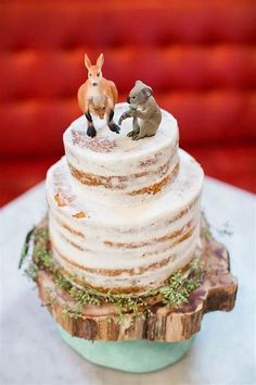 an image of a wedding cake with animals on top