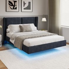 a bed with blue lights on the bottom and sides in a gray room next to a white rug