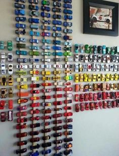 there are many cars on the wall next to each other