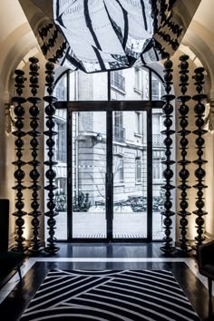 the entrance to an apartment building is decorated with black and white art work, including zebra - print rugs