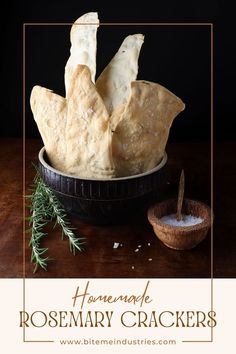 Small bowl of maldon salt next to a large bowl of homemade rosemary crackers.