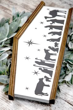 a bookmark with the silhouettes of dogs and stars on it next to some leaves