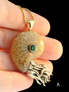 "This remarkable Nautilus Pendant features an ammonite fossil bezel set with a 5mm gemstone. These are the first of Alisha's Nautilus' to be cast in 14k Gold. Alisha hand picks each fossilized ammonite and finding specimens of this quality is rare. These pendants measure approximately 2\" diagonally from the bail to the tip of the tentacles. They are drilled and pegged securely into especially beautiful miniature fossilized ammonite shells. The fossilized shells shimmer subtly with iridescence a Unique Untreated Yellow Gold Jewelry, Ammonite Jewelry, Dope Jewelry Accessories, Whimsical Accessories, Fossil Jewelry, Ammonite Fossil, Dope Jewelry, Shell Jewelry, Rings Jewelry