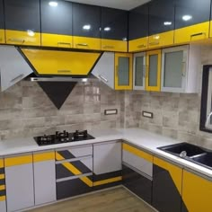 a kitchen with yellow and grey cabinets and counters