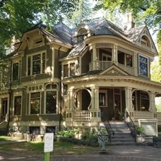 an old victorian style house in the woods