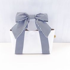 a white box with a blue and white bow on it