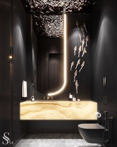 a modern bathroom with black walls and flooring is lit up by the lights above the sink