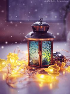 a lantern is sitting on the ground with some lights around it and happy new year written in