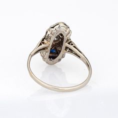 Finely detailed vintage Art Deco diamond & sapphire ring (circa 1920s to 1930s) crafted in 14k white gold.   One estimated 0.10 carat old European cut diamonds is estimated at J-K colour and I1 clarity. Four sapphires (lab) total an estimated 0.15 carats.    The stylish Art Deco era ring is set with an old European cut diamond to the centre, flanked with triangular cut sapphires. The small plaque ring is great for day or evening wear. The ring has a low profile and rises 5mm from the finger (0.1 Art Deco Target Ring, Art Deco Sapphire Ring With Polished Finish, Art Deco Sapphire Ring With Vvs Clarity, Art Deco Diamond Sapphire Ring, Luxury Art Deco Sapphire Ring In Platinum, Collectible Art Deco Platinum Sapphire Ring, Art Deco Platinum Diamond-studded Jewelry, Stylish Art, Art Deco Diamond Rings