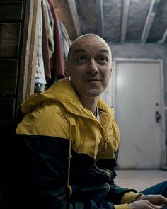 a man sitting on the floor in front of a closet