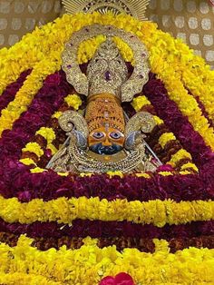 an idol is placed in the middle of flowers