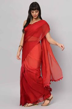 Introducing our stunning Red 4-Shade Organza Saree, a timeless piece that shows grace and charm. Crafted from high-quality organza in four captivating shades of red, this saree is a true work of art. Paired with a sleeveless blouse made from rich red raw silk, it's a perfect outfit to make a bold and elegant statement at any occasion. About this Product Saree: Saree Color: Red Saree Fabric: Georgette Organza Type of Work: Four colors shaded Trim: Tassel-work on pallu Drape Style: Choose the drap Red Chanderi Pre-draped Saree With Unstitched Blouse, Red Chanderi Pre-draped Saree With Dupatta, Red Pre-draped Saree With Sheer Dupatta For Puja, Elegant Red Silk Pre-draped Saree, Fusion Silk Saree With Sheer Dupatta, Fusion Style Silk Saree With Sheer Dupatta, Red Organza Floor-length Saree, Red Silk Pre-draped Saree For Navratri, Floor-length Red Organza Saree