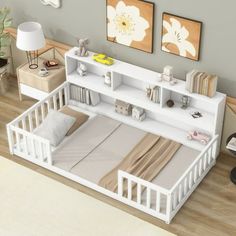 a white bed sitting on top of a wooden floor