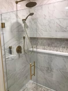 a walk in shower sitting next to a bath tub