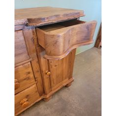 an old wooden dresser with drawers in a room