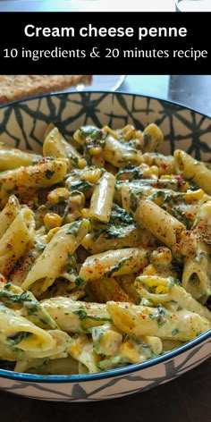 a bowl filled with pasta covered in cheese and spinach sauce on top of a table