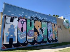 a large mural on the side of a building that says houston painted in different colors