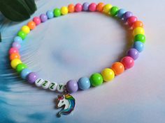 Personalised (Custom) Necklace for Boys and Girls, with unicorn charm Great idea for first, second, third  Birthday party. For your own child or as a birthday gift to a friend.  Necklace are made out of rainbow colours 10mm acrylic round beads, Letters are 7mm, color beada. those beads could be in green or in any other colour. Add unicorn charm if you want to. This Listing is for ONE custom necklace This product can have your Child Name, or just a phrase such as: Happy, Smile, Joy, Best Friend, Playful Rainbow Jewelry With Letter Beads, Beads Letters, Playful Rainbow Letter Beads Necklace, Personalized Pink Kawaii Necklace, Rainbow Wooden Beads Necklace, Rainbow Necklaces With Heart-shaped Beads, Necklace For Kids, Kids Rainbow, Personalised Necklace