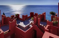 an aerial view of a red building near the ocean